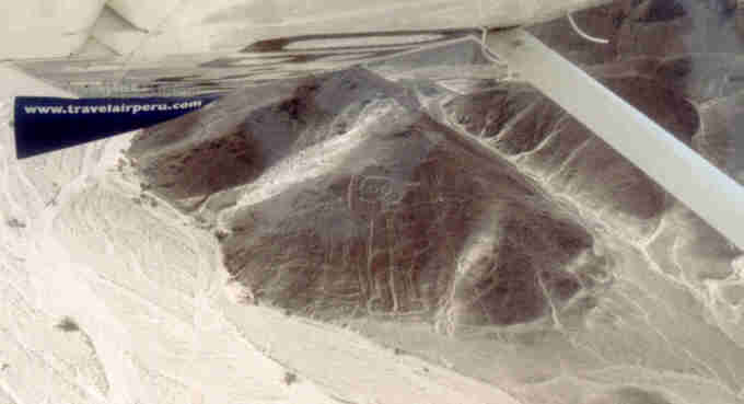 Flying over the figure known as the 'spaceman' in the desert near Nazca, Peru